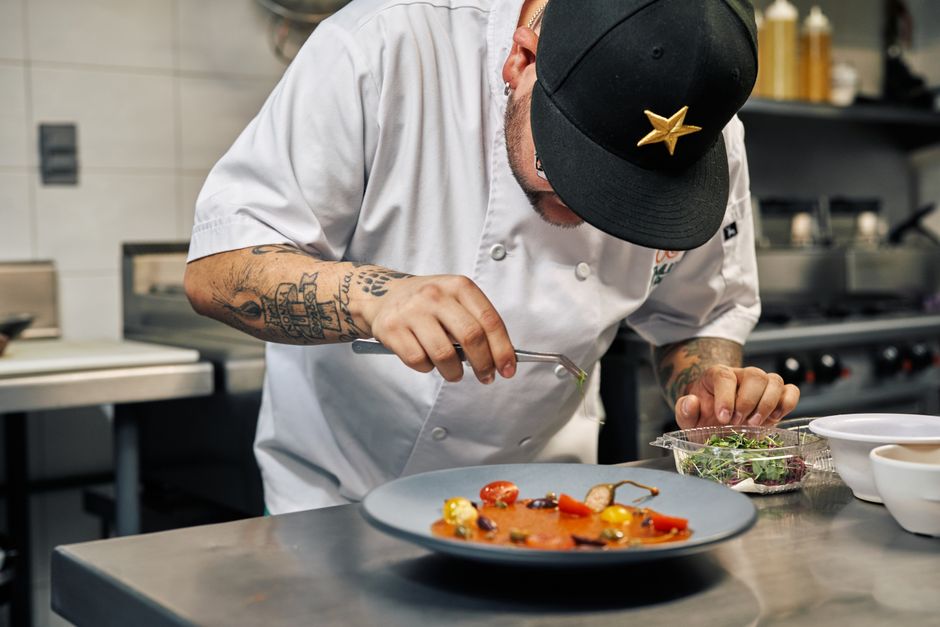 Professional chef carefully plating gourmet food