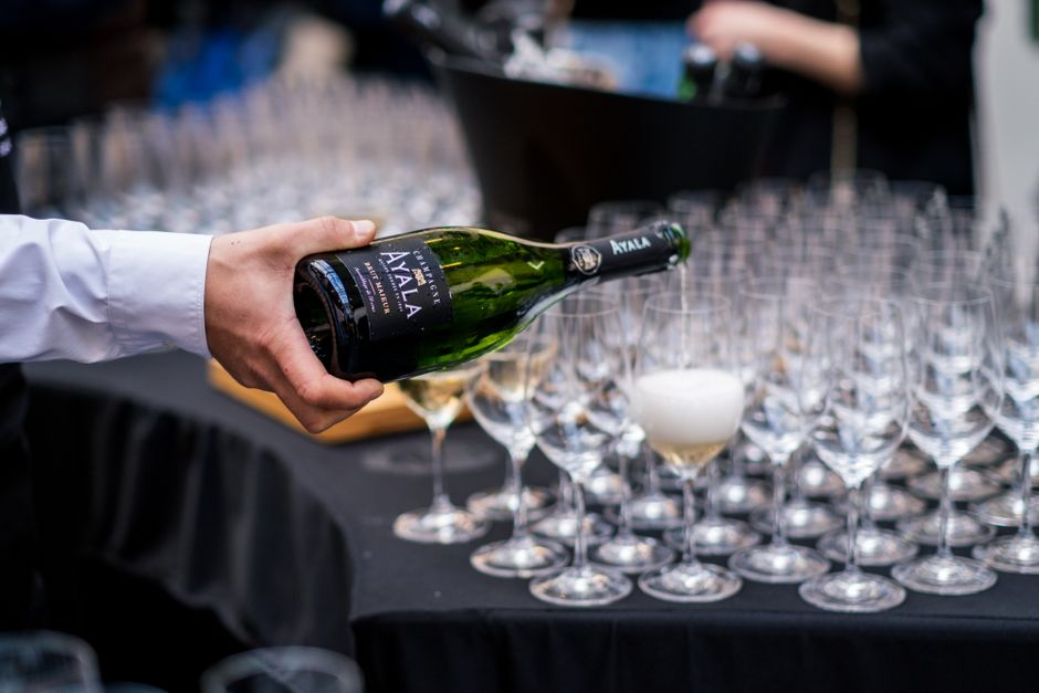 A professional bartender pouring champagne at a social event